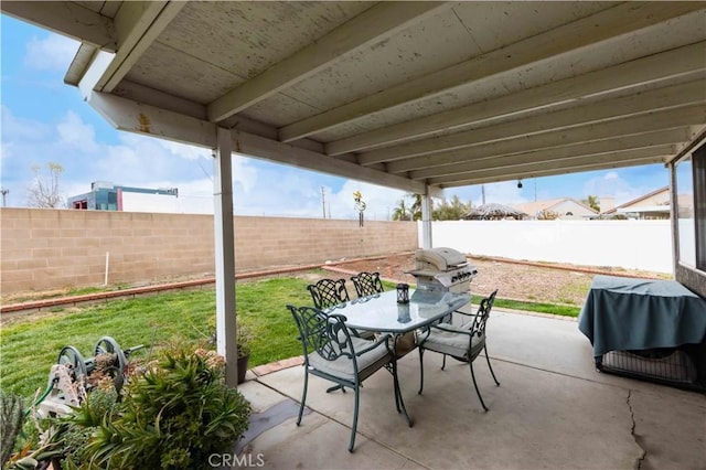 view of patio with outdoor dining space, a fenced backyard, and a grill