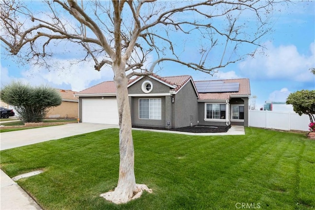 ranch-style house featuring stucco siding, a tile roof, fence, concrete driveway, and solar panels