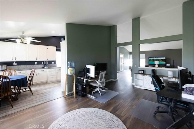 office area featuring baseboards, high vaulted ceiling, ceiling fan, and wood finished floors