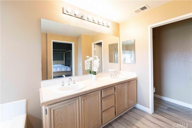 bathroom featuring double vanity, toilet, visible vents, and a sink