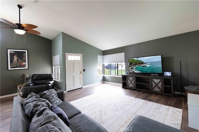 living room featuring a ceiling fan, vaulted ceiling, wood finished floors, and baseboards