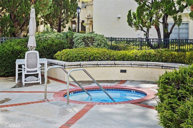 view of pool featuring a patio area, a community hot tub, and fence