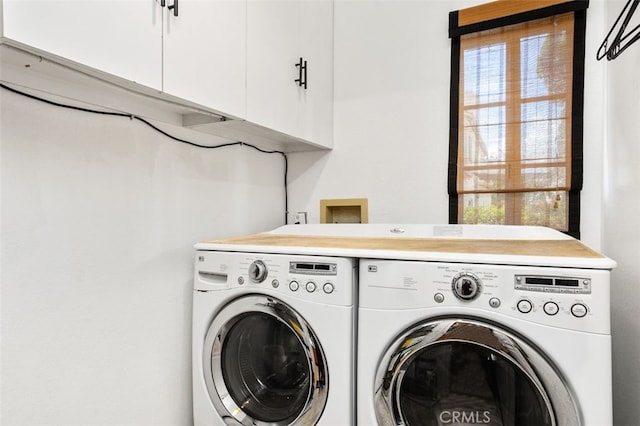 laundry area with cabinet space, washer and dryer, and a wealth of natural light