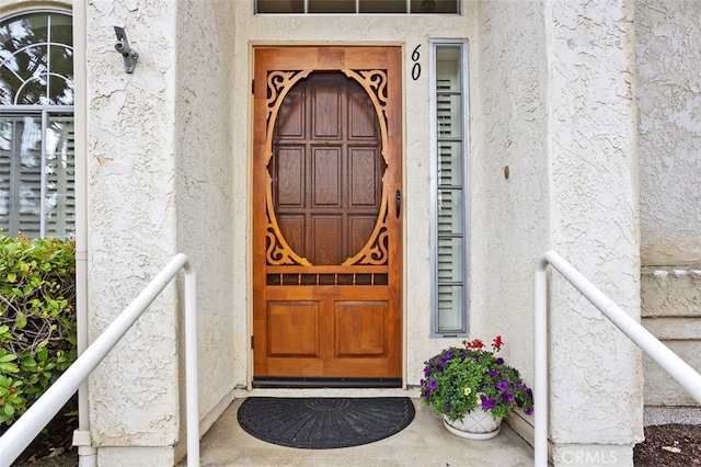 property entrance with stucco siding