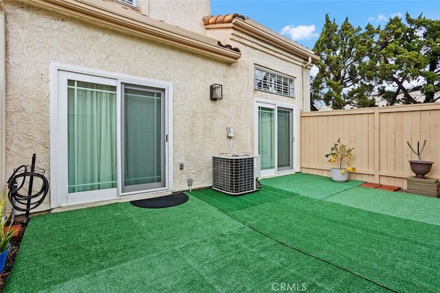 exterior space featuring central AC unit and fence