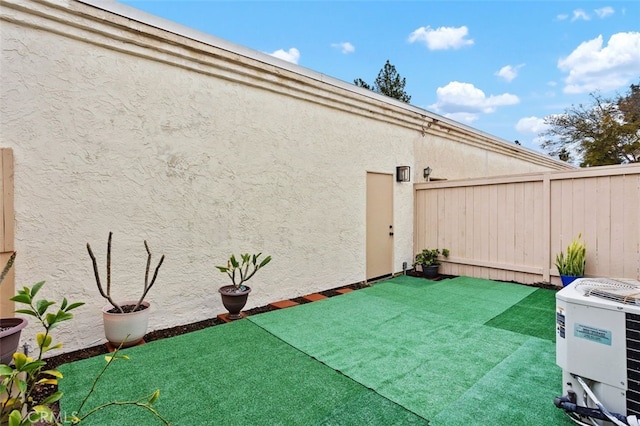 view of patio / terrace with central AC unit and fence