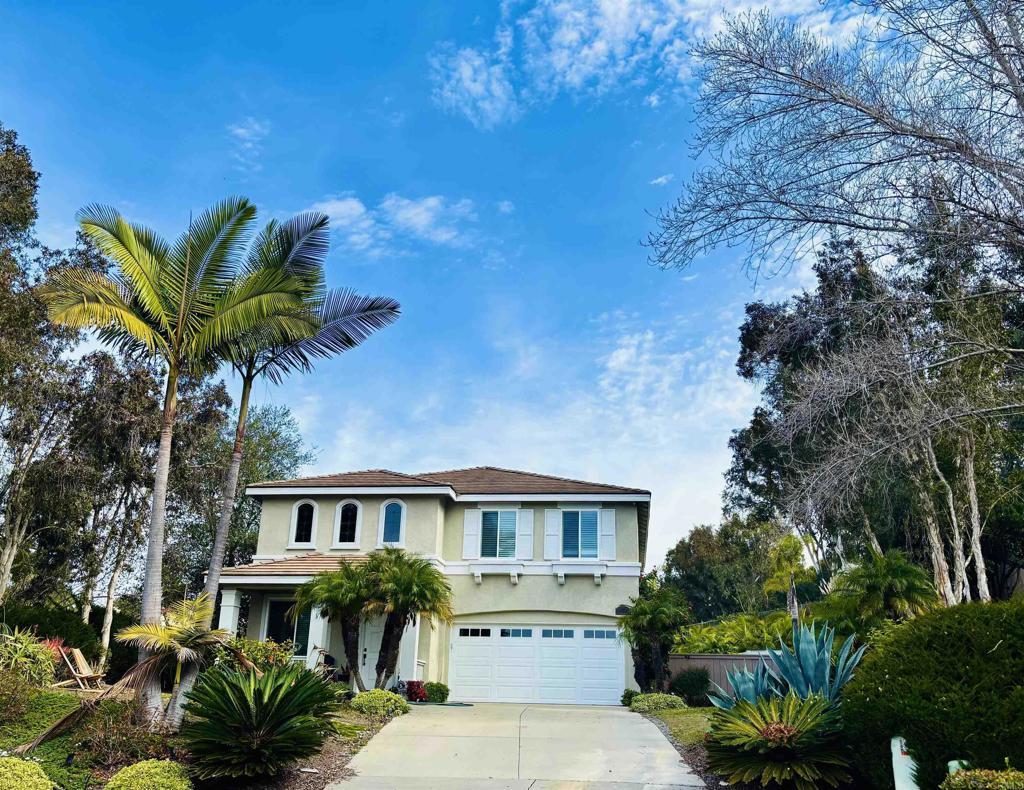 mediterranean / spanish home featuring stucco siding, an attached garage, and concrete driveway