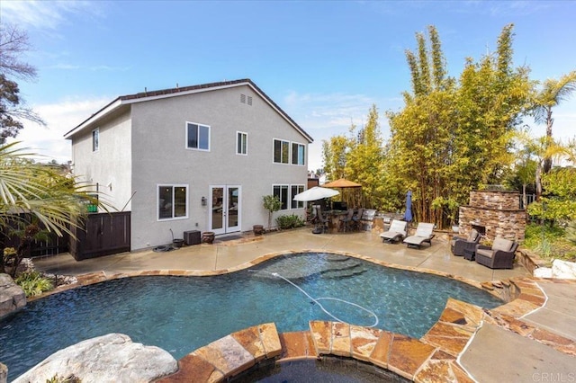 1905 Oxford Ct, Vista, CA 92081 - outdoor pool featuring a patio area, french doors, and an outdoor living space with a fireplace