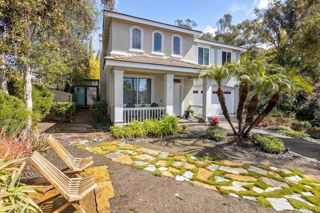 1905 Oxford Ct, Vista, CA 92081 - view of front facade with a porch, stucco siding, an attached garage, and driveway
