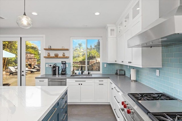1905 Oxford Ct, Vista, CA 92081 - kitchen featuring wall chimney range hood, healthy amount of natural light, appliances with stainless steel finishes, white cabinets, and recessed lighting