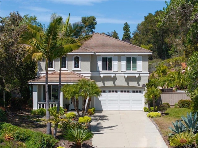 1905 Oxford Ct, Vista, CA 92081 - view of front of house featuring stucco siding, concrete driveway, an attached garage, a tiled roof, and covered porch