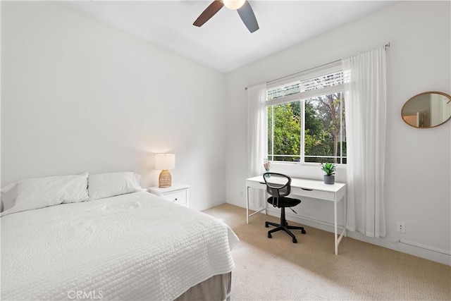 bedroom featuring light colored carpet and ceiling fan