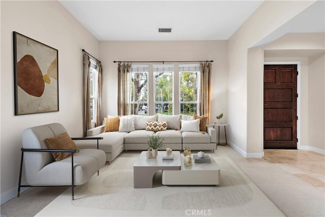 living room featuring visible vents and baseboards