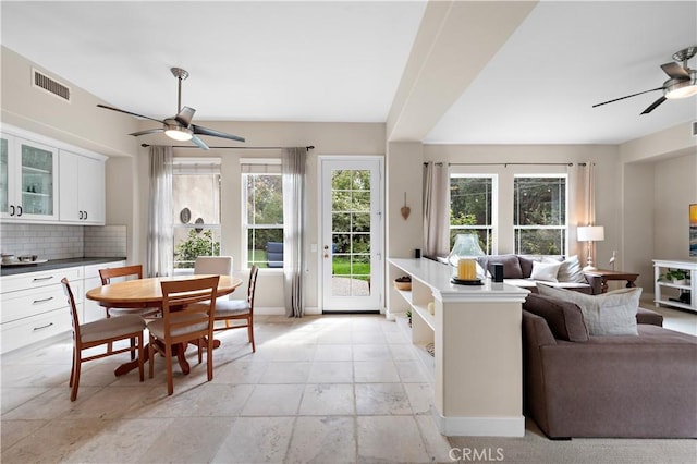 interior space with visible vents, baseboards, and ceiling fan