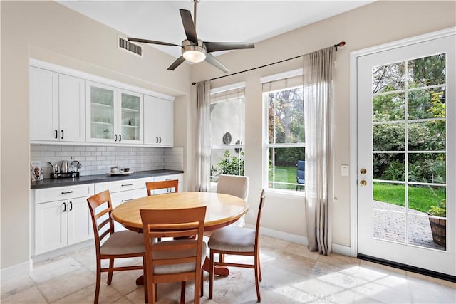 dining room with visible vents, baseboards, and ceiling fan