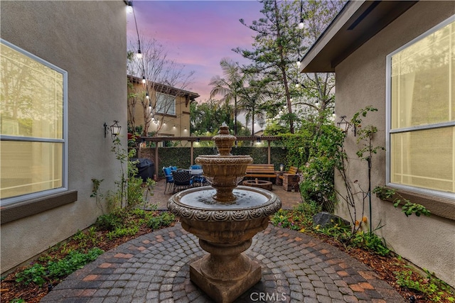 view of patio terrace at dusk