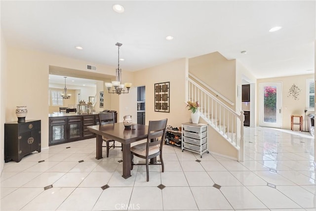 dining room featuring stairs, an inviting chandelier, light tile patterned flooring, and recessed lighting