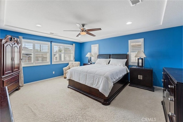 carpeted bedroom with visible vents and ceiling fan