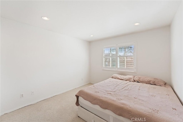 carpeted bedroom featuring recessed lighting and baseboards