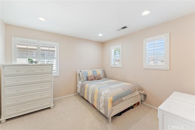 bedroom with recessed lighting, visible vents, light carpet, and baseboards