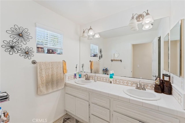 full bathroom with a sink and double vanity