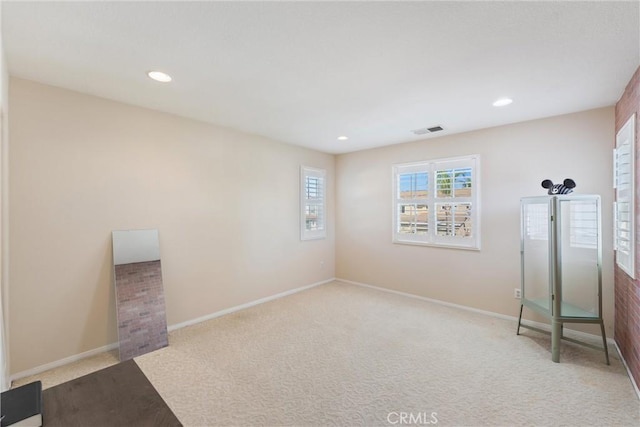 unfurnished bedroom with recessed lighting, visible vents, carpet floors, and baseboards