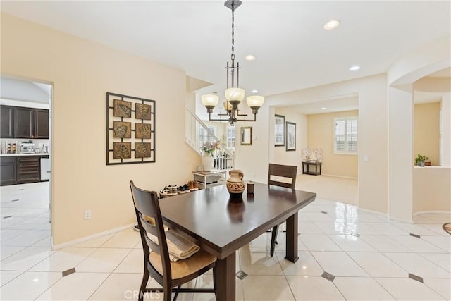 dining space with light tile patterned floors, recessed lighting, baseboards, and a chandelier