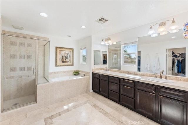 bathroom with a sink, visible vents, double vanity, and a shower stall