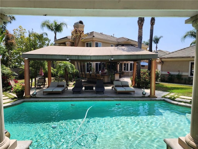 pool with a gazebo and a patio