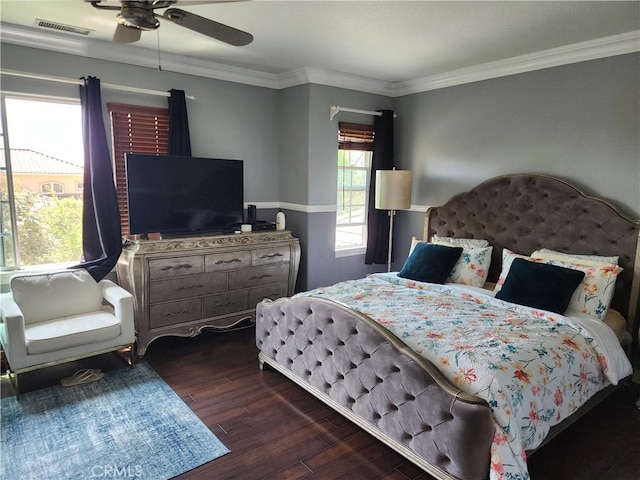 bedroom with crown molding, a ceiling fan, visible vents, and dark wood-style flooring