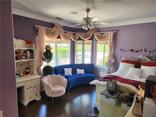 bedroom featuring visible vents, wood finished floors, ornamental molding, and a ceiling fan