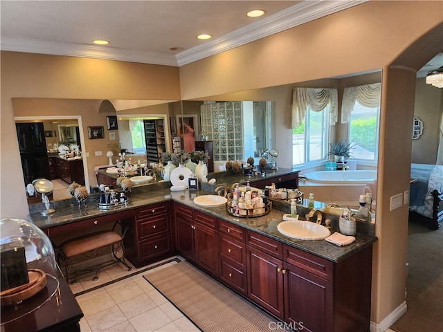 bathroom featuring a sink, ornamental molding, and tile patterned flooring