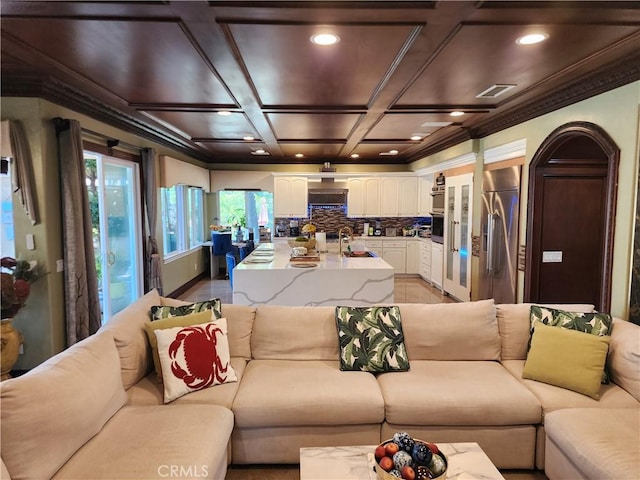 living room featuring visible vents, recessed lighting, coffered ceiling, and ornamental molding