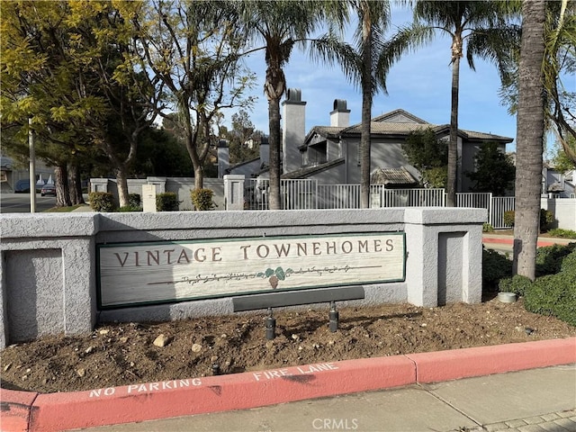 community sign featuring fence