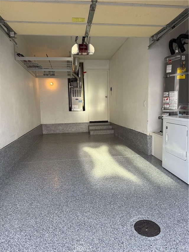 garage featuring heating unit, washing machine and dryer, a garage door opener, and water heater