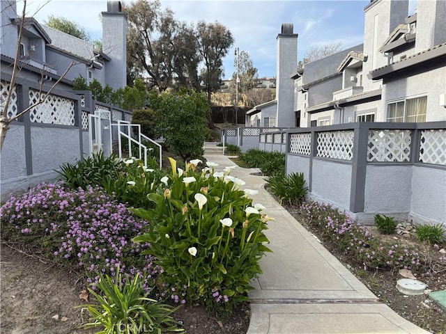 view of property's community with fence and a residential view