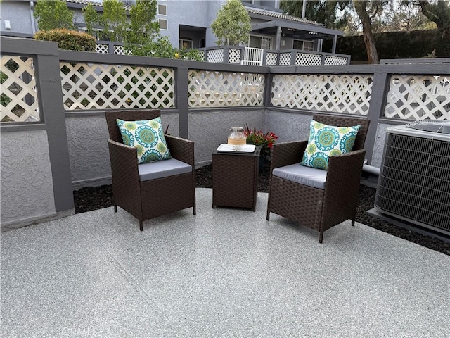 view of patio featuring cooling unit and fence