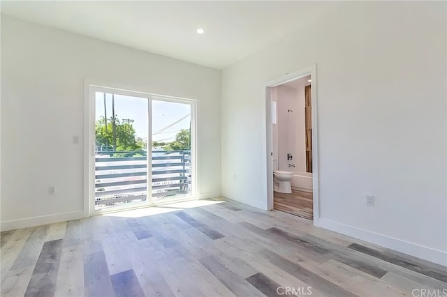 empty room with baseboards and wood finished floors