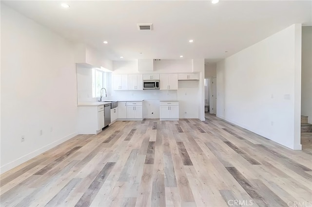 kitchen with visible vents, recessed lighting, appliances with stainless steel finishes, white cabinetry, and a sink