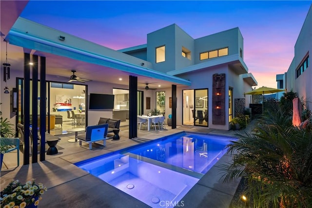 outdoor pool featuring a patio area, outdoor dining space, an in ground hot tub, and a ceiling fan