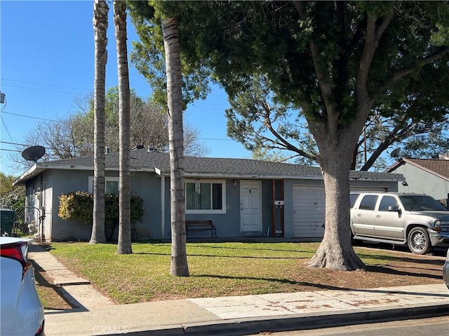 single story home featuring a front lawn, an attached garage, roof with shingles, and stucco siding