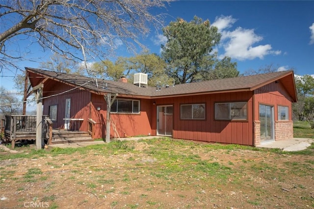 back of house with central AC unit