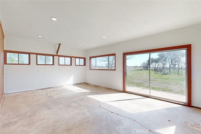 spare room with recessed lighting and unfinished concrete floors