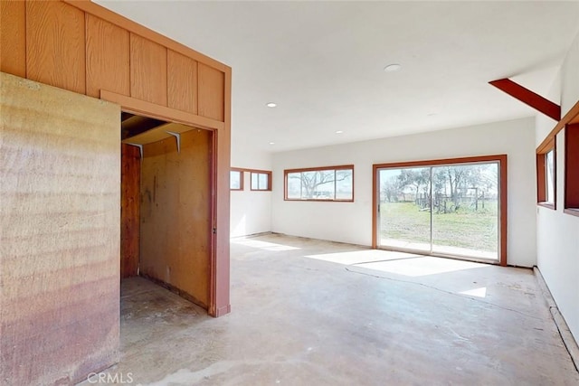 unfurnished room featuring unfinished concrete flooring