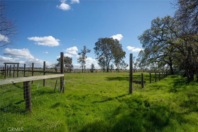 view of yard featuring a rural view and fence