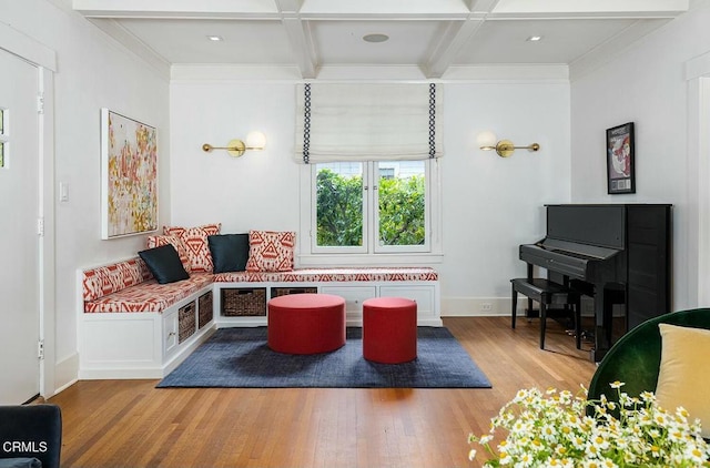 living area featuring crown molding, beamed ceiling, wood finished floors, and coffered ceiling