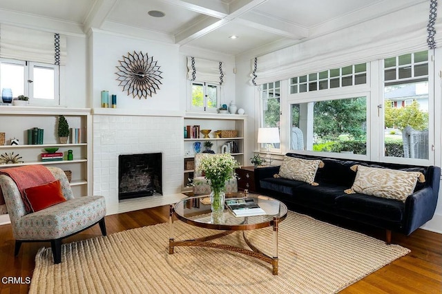 living room with coffered ceiling, a healthy amount of sunlight, and wood finished floors