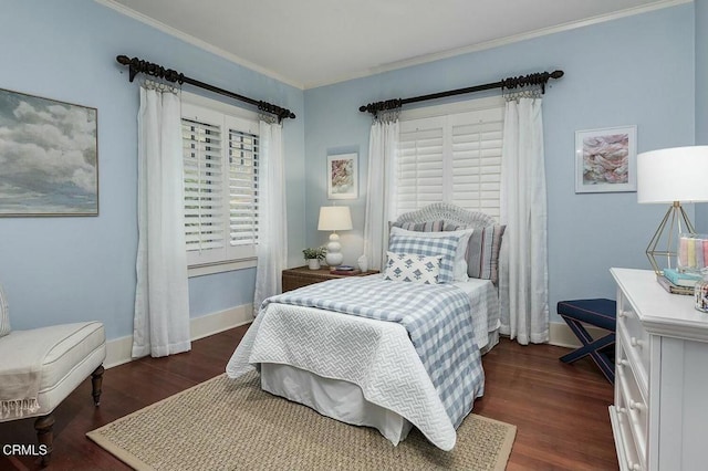 bedroom with crown molding, wood finished floors, and baseboards