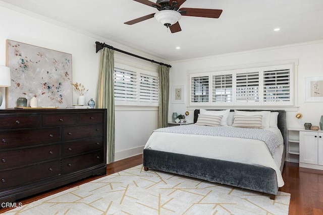 bedroom featuring a ceiling fan, wood finished floors, baseboards, recessed lighting, and ornamental molding