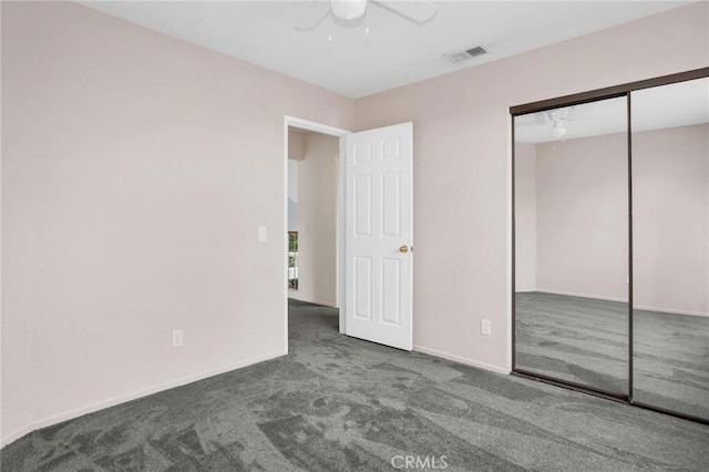 unfurnished bedroom featuring visible vents, a closet, carpet floors, baseboards, and ceiling fan